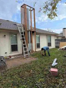 Chimney installation process in Dallas with frame and ladder